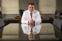 Male doctor seating at a table