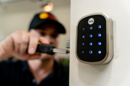 Male installing security keypad