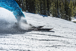 Person sliding down hill skiing