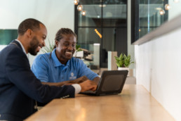 Male coworkers working on computer